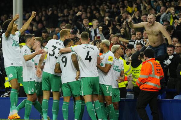 Newcastle's team players celebrate after scoring their side's second goal during the English Premier League soccer match between Everton and Newcastle United at the Goodison Park stadium in Liverpool, England, Thursday, April 27, 2023. (AP Photo/Jon Super)