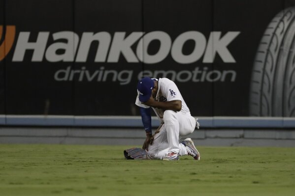 
              Los Angeles Dodgers' Yasiel Puig reacts after diving for a ball hit by Houston Astros' Alex Bregman during the eighth inning of Game 2 of baseball's World Series Wednesday, Oct. 25, 2017, in Los Angeles. (AP Photo/David J. Phillip)
            