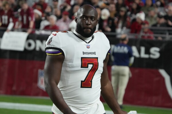 FILE - Tampa Bay Buccaneers running back Leonard Fournette (7) is shown during the second half of an NFL football game against the Arizona Cardinals, Sunday, Dec. 25, 2022, in Glendale, Ariz. Fournette appears to have avoided injury after his car caught fire while he was driving on a freeway. Fournette posted a video to Instagram on Tuesday, June 27, 2023, where he showed his burned vehicle on the side of the highway. Fournette, who was a first-round pick by Jacksonville in 2017, is currently a free agent after being released by the Bucs during the offseason in a salary cap move. (AP Photo/Rick Scuteri, File)
