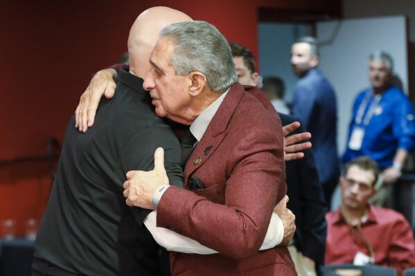 Atlanta Falcons owner Arthur Blank, right, embraces Falcons head coach Dan Quinn after an NFL football game against the Seattle Seahawks, Sunday, Oct. 27, 2019, in Atlanta. Atlanta coach Dan Quinn has been fired after the Falcons dropped to 0-5 for the first time since 1997. The move came just hours after the Falcons lost to the Carolina Panthers 23-16, Sunday, Oct. 11, 2020. The team also fired longtime general manager Thomas Dimitroff, who had been with the team since 2008. (AP Photo/John Bazemore)