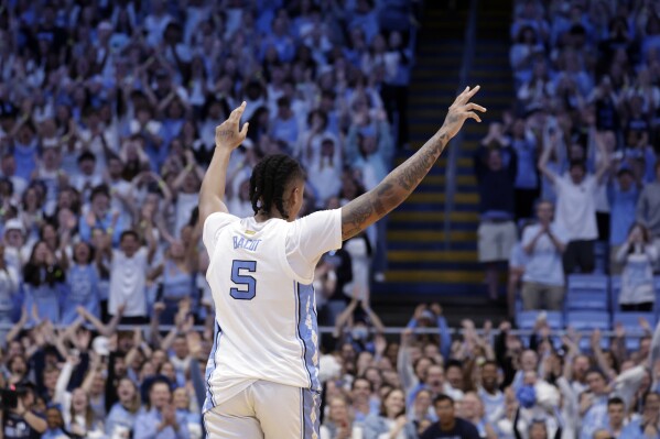 North Carolina forward Armando Bacot (5) gestures to the crowd as leaves in the final minutes of the team's NCAA college basketball game against Notre Dame, Tuesday, March. 5, 2024, in Chapel Hill, N.C. (AP Photo/Chris Seward)