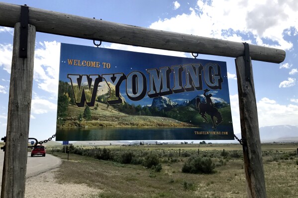 A sign on the border of Wyoming and Montana appears on the side of Belfry Highway, May 24, 2017, in Powell, Wyoming. Republican party officials in two Wyoming counties will meet on Saturday, Feb. 24, 2024, to begin awarding the first of the state's 29 delegates to the Republican National Convention this summer, but the contest won't resemble any other presidential vote held so far this year. The state is one of a handful to use a "caucus-convention" system. (AP Photo/Robert Yoon)