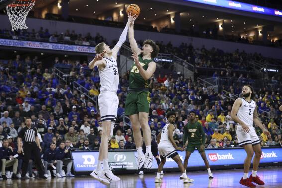 Oral Roberts' Connor Vanover (35) blocks a shot by North Dakota State's Andrew Morgan (23) during the first half of an NCAA college basketball game for the Summit League men's tournament championship Tuesday, March 7, 2023, in Sioux Falls, S.D. (AP Photo/Josh Jurgens)
