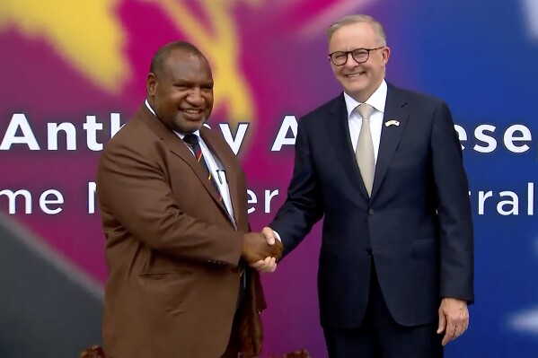 FILE - In this image from a video, Australian Prime Minister Anthony Albanese, right, and Papua New Guinea's Prime Minister James Marape shake hands outside the parliament in Port Moresby, Papua New Guinea Thursday, Jan. 12, 2023. Papua New Guinea's Prime Minister James Marape said Tuesday, Dec. 5, 2023, that he will sign a bilateral security pact with Australia during an Australian visit this week. (Australia Pool via 鶹ýapp/File)