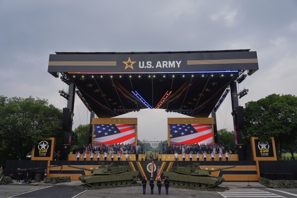 The colors are presented as President Donald Trump attends a military parade commemorating the Army's 250th anniversary, coinciding with his 79th birthday, Saturday, June 14, 2025, in Washington. (AP Photo/Julia Demaree Nikhinson)