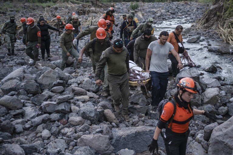 Rescuers recover the body of a policeman who state authorities said died in a car accident while checking damage caused by heavy rain in Alto Lucero, Veracruz, Mexico, Tuesday, July 2, 2024. (AP Photo/Felix Marquez)