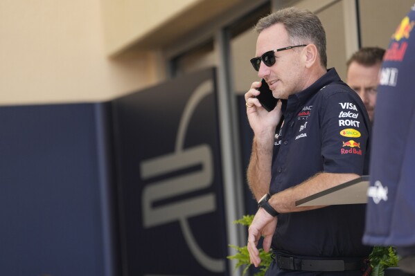 Red Bull team principal Christian Horner speaks on a mobile phone prior to the first practice session ahead of the Formula One Bahrain Grand Prix at the Bahrain International Circuit in Sakhir, Bahrain, Thursday, Feb. 29, 2024. (AP Photo/Darko Bandic)