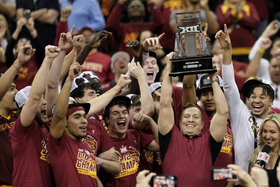 Iowa State head coach T.J. Otzelberger hoists the trophy after winning an NCAA college basketball game against Houston to win the championship of the Big 12 Conference tournament, Saturday, March 16, 2024, in Kansas City, Mo. Iowa State won 69-41. (AP Photo/Charlie Riedel)