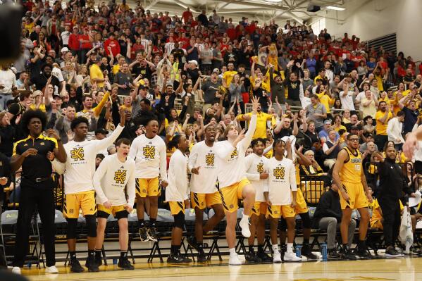 Kennesaw State's bench and fans react after a basket during the second half of the ASUN Conference championship basketball game against Liberty, Sunday, March 5, 2023, in Kennesaw, Ga. (Miguel Martinez/Atlanta Journal-Constitution via AP)