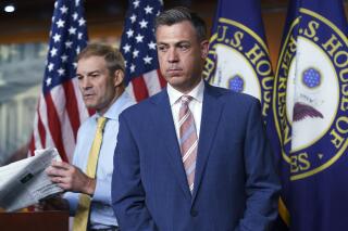 FILE - Rep. Jim Banks, R-Ind., right, and Rep. Jim Jordan, R-Ohio, left, exchange places at the podium during a news conference at the Capitol in Washington, Wednesday, July 21, 2021. Banks, who was rejected by House Speaker Nancy Pelosi as the top Republican for the committee investigating last year's U.S. Capitol insurrection is fending off an effort to remove his name from this year's election ballot. (AP Photo/J. Scott Applewhite, File)
