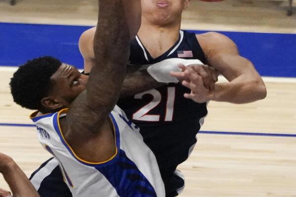 Virginia's Kadin Shedrick (21) blocks a shot by Pittsburgh's Jamarius Burton during the second half of an NCAA college basketball game, Wednesday, Jan. 19, 2022, in Pittsburgh. Virginia won 66-61. (AP Photo/Keith Srakocic)
