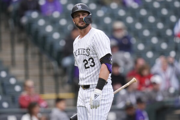 Colorado Rockies' Kris Bryant heads to the dugout after striking out against Arizona Diamondbacks relief pitcher Kevin Ginkel in the ninth inning of a baseball game Wednesday, April 10, 2024, in Denver. (AP Photo/David Zalubowski)