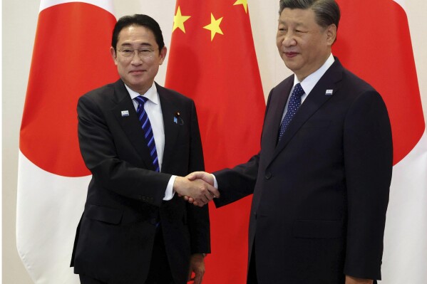 Japanese Prime Minister Fumio Kishida, left, and Chinese President Xi Jinping shake hands prior to their bilateral talk in San Francisco, Ca., Thursday, Nov. 16, 2023. (Kyodo News via AP)