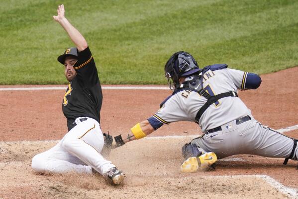 Pittsburgh Pirates' Greg Allen, left, scores past the tag of Milwaukee Brewers catcher Victor Caratini (7) on a hit by Ben Gamel in the seventh inning the a baseball game, Thursday, Aug. 4, 2022, Pittsburgh. (AP Photo/Keith Srakocic)