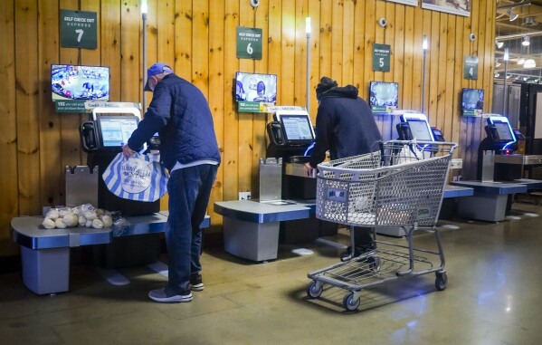 Customers use self-checkout kiosks at Stew Leonard's grocery store in Paramus, N.J., Wednesday, Dec. 13, 2023, in New York. Self-checkout faces a reckoning of sorts just as retailers are in the midst of their busiest time of the year. (AP Photo/Bebeto Matthews)