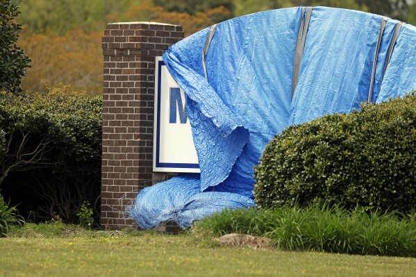 The sign for the vacant Martin County General Hospital sits under a blue tarp since being closed in August of 2023 in Williamston, N.C., Wednesday, April 10, 2024. After Williamston only hospital closed, residents there say they're not only worried about their health but they've lost trust in politicians. The struggle to reopen its only emergency room could signal trouble for President Joe Biden's re-election campaign, which is centered around his health care accomplishments. (AP Photo/Karl B DeBlaker)