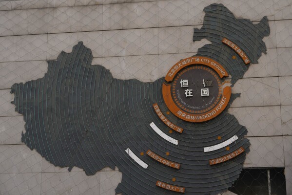 Letterings are missing on a depiction of Evergrande properties across a China map at a partially shuttered Evergrande commercial complex in Beijing, Monday, Jan. 29, 2024. Chinese property developer China Evergrande Group on Monday was ordered to liquidate by a Hong Kong court, after the firm was unable to reach a restructuring deal with creditors. (AP Photo/Ng Han Guan)