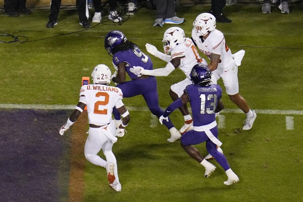 TCU running back Emani Bailey (9) rushes for a touchdown against Texas during the second half of an NCAA college football game, Saturday, Nov. 11, 2023, in Fort Worth, Texas. Texas won 29-26. (AP Photo/Julio Cortez)