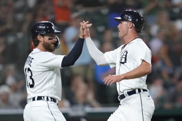 Detroit Tigers' Eric Haase, left, and Kerry Carpenter celebrate scoring against the Minnesota Twins in the eighth inning of a baseball game, Tuesday, Aug. 8, 2023, in Detroit. (AP Photo/Paul Sancya)