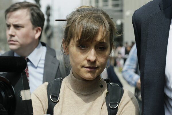 
              Actress Allison Mack leaves Brooklyn federal court Monday, April 8, 2019, in New York. Mack pleaded guilty to racketeering charges on Monday in a case involving a cult-like group based in upstate New York. The trial is expected to detail sensational allegations that the group, called NXIVM, recruited sex slaves for its spiritual leader, Keith Raniere.(AP Photo/Mark Lennihan)
            