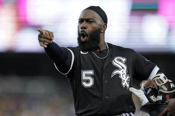 Chicago White Sox's Josh Harrison jokes with players in the San Diego Padres dugout during the sixth inning of a baseball game Friday, Sept. 30, 2022, in San Diego. (AP Photo/Gregory Bull)