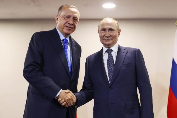FILE - In this handout photo provided by the Turkish Presidency, Turkish President Recep Tayyip Erdogan, left, shakes hands with Russian President Vladimir Putin during their meeting, in Tehran, Iran, July 19, 2022. The Biden administration likes to say that Russia is now isolated internationally because of its invasion of Ukraine. Yet its top officials are hardly sitting lonely and isolated in the Kremlin and now the U.S. wants to talk.(Turkish Presidency via AP, File)