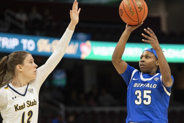 Buffalo's Chellia Watson (35) shoots over Kent State's Jenna Batsch (12) during the first half of an NCAA college game in the championship of the Mid-American Conference tournament, Saturday, March 16, 2024, in Cleveland. (AP Photo/Phil Long)