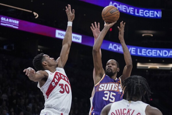 Phoenix Suns forward Kevin Durant (35) shoots over Toronto Raptors guard Ochai Agbaji (30) during the second half of an NBA basketball game in Phoenix, Thursday, March. 7, 2024. Phoenix won 120-113. (AP Photo/Darryl Webb)