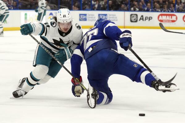 San Jose Sharks center Michael Eyssimont (21) takes down Tampa Bay Lightning defenseman Victor Hedman (77) during the first period of an NHL hockey game Tuesday, Feb. 7, 2023, in Tampa, Fla. (AP Photo/Chris O'Meara)