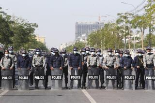 Police in riot gear for am line blocking protesters during a demonstration in Mandalay, Myanmar, Tuesday, Feb. 9, 2021. Protesters continued to gather Tuesday morning in major cities breaching Myanmar's new military rulers' ban of public gathering of five or more issued on Monday intended to crack down on peaceful public protests opposing their takeover. (AP Photo)