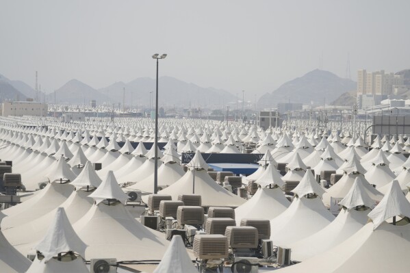Tents of Muslim pilgrims fill the Mina Tent Camp as Muslim pilgrims arrive during the annual Hajj, near the holy city of Mecca, Saudi Arabia, Friday, June 14, 2024. (AP Photo/Rafiq Maqbool)