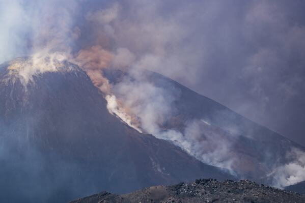 Smoke billows from Mount Etna volcano, Italy, Monday, June 2, 2025. (AP Photo/Giuseppe Distefano)