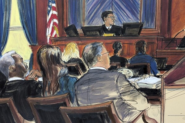 Sean 'Diddy' Combs, far left, looks on from the defense table with his attorneys, as a prospective juror, far right, answers questions posed by Judge Arun Subramanian, center, at Manhattan federal court, Monday, May 5, 2025, in New York. (Elizabeth Williams via AP)