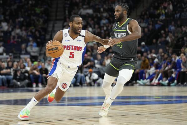 Detroit Pistons guard Alec Burks (5) works towards the basket against Minnesota Timberwolves guard Jaylen Nowell (4) during the first half of an NBA basketball game, Saturday, Dec. 31, 2022, in Minneapolis. (AP Photo/Abbie Parr)