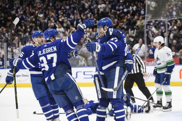 The Toronto Maple Leafs celebrate after left wing Pierre Engvall (47) scored against the Vancouver Canucks during the second period of an NHL hockey game in Toronto, Saturday, Nov. 12, 2022. (Christopher Katsarov/The Canadian Press via AP)