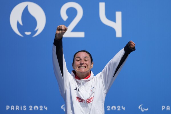 Britain's Sarah Storey celebrates on the podium after winning the women's C4-5 road race during the 2024 Paralympics, Friday, Sept. 6, 2024, in Clichy-sous-Bois, France. (AP Photo/Aurelien Morissard)