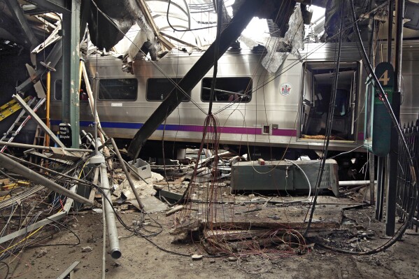 FILE – This photo provided by the National Transportation Safety Board, shows damage from a Sept. 29, 2016, commuter train crash that killed a woman and injured more than 100 people at the Hoboken Terminal in Hoboken, N.J. The National Transportation Safety Board issued a report Wednesday, Nov. 1, 2023, urging the Federal Railroad Administration and the industry to keep developing new technology that can be used to improve Positive Train Control systems. But their recommendations include at least one practical idea that railroads could likely implement relatively quickly. (Chris O'Neil/National Transportation Safety Board via AP, File)