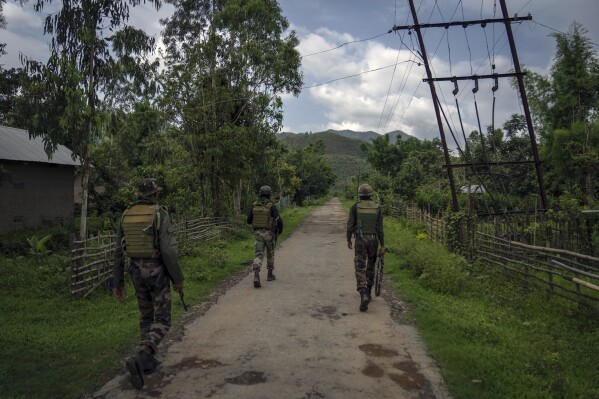 Indian army soldiers patrol a deserted village in Churachandpur, in the northeastern Indian state of Manipur, Tuesday, June 20, 2023. (AP Photo/Altaf Qadri)