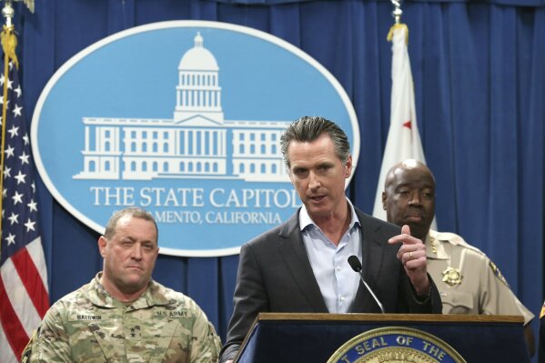 
              California Gov. Gavin Newsom, center, discusses his decision to withdraw several hundred National Guard troops from the nation's southern border and changing their mission, during a Capitol news conference Monday, Feb. 11, 2019, in Sacramento, Calif. Newsom, flanked by Major General David Baldwin, the Adjutant General of the California Military Department, left, and California Highway Patrol Commissioner Warren Stanley, right, said he will order the troops to leave by the end of March but will leave 100 troops to focus on drug trafficking. (AP Photo/Rich Pedroncelli)
            