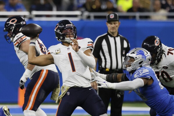 Chicago Bears quarterback Justin Fields (1) is pressured during the second half of an NFL football game against the Detroit Lions, Sunday, Nov. 19, 2023, in Detroit. (AP Photo/Duane Burleson)