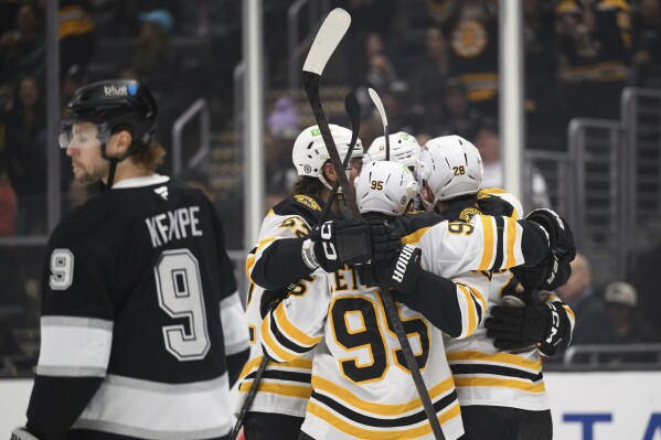 Boston Bruins players celebrate after a goal by center Elias Lindholm (28) during the first period of an NHL hockey game against the Los Angeles Kings, Sunday, March 23, 2025, in Los Angeles. (AP Photo/William Liang)