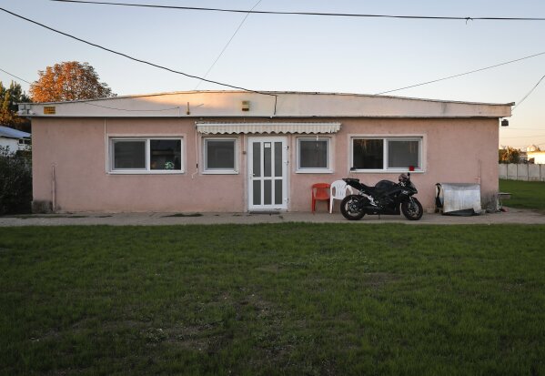 
              FILE - In this Oct. 4, 2017, file photo, a motorcycle is parked outside the THCServers.com company headquarters, outside Craiova, southern Romania. The company based in a remote part of the eastern European country was used to register the website DCLeaks, which U.S. intelligence has accused of being a front for Russian spies. (AP Photo/Vadim Ghirda, File)
            
