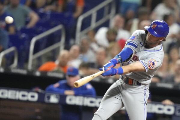 New York Mets' Jeff McNeil hits a solo home run during the ninth inning of a baseball game against the Miami Marlins, Monday, Sept. 18, 2023, in Miami. (AP Photo/Lynne Sladky)