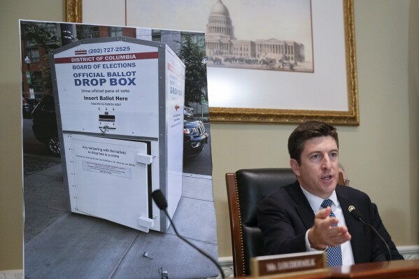 Bryan Steil, R-Wis., chairman of the Committee on House Administration, displays a large photo of an unlocked election ballot drop box in Washington, during a hearing about noncitizen voting in U.S. elections. on Capitol Hill, Thursday, May 16, 2024 in Washington. In recent months, the specter of noncitizens voting in the U.S. has erupted into a leading rallying cry for Republicans. (Ǻ Photo/John McDonnell)