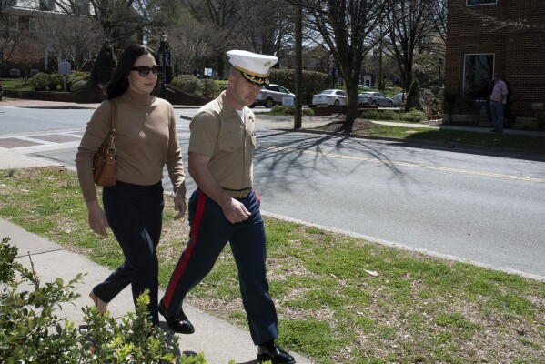 FILE - Marine Maj. Joshua Mast and his wife, Stephanie, arrive at Circuit Court, Thursday, March 30, 2023, in Charlottesville, Va. Joshua Mast helped an Afghan couple and a young girl in their care flee as their country collapsed and the Taliban took over. Days after they arrived in the U.S., the Masts worked with federal employees at a refugee resettlement camp to take custody of the child. The Afghan couple are suing to get her back. (AP Photo/Cliff Owen, File)