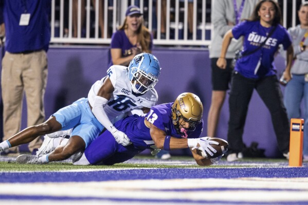 James Madison wide receiver Elijah Sarratt (13) is tackled by Old Dominion cornerback Khian'Dre Harris (16) short of the goal line during the first half of an NCAA college football game Saturday, Oct. 28, 2023, in Harrisonburg, Va. (AP Photo/Mike Caudill)