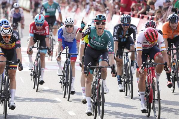 Ireland's Sam Bennett celebrates as hecrosses the finish line to win the second stage of the Vuelta cycling race over 175.1 kilometers (108.8 miles) with start in Den Bosch and finish in Utrecht, Netherlands, Saturday, Aug. 20, 2022. (AP Photo/Peter Dejong)