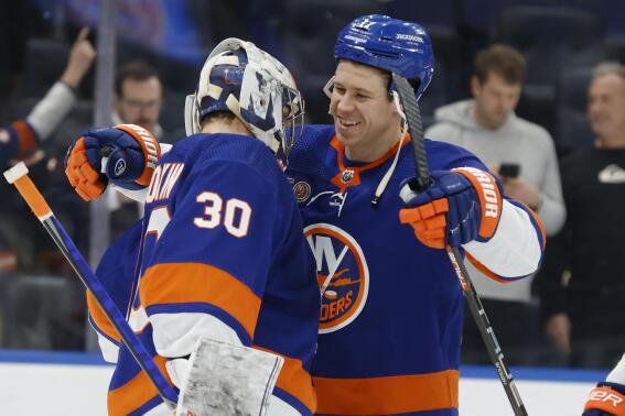 New York Islanders' Matt Martin, right, hugs goalie Ilya Sorokin (30) after defeating the Buffalo Sabres during an NHL hockey game Tuesday, March 7, 2023, in Elmont, N.Y. (AP Photo/Jason DeCrow)