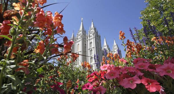 FILE - Flowers bloom in front of the Salt Lake Temple, at Temple Square, on Aug. 4, 2015, in Salt Lake City. The Church of Jesus Christ of Latter-day Saints on Tuesday, Nov. 15, 2022, came out in support of The Respect for Marriage Act under consideration in Congress after years of opposing recognition of same-sex marriage. (AP Photo/Rick Bowmer, File)