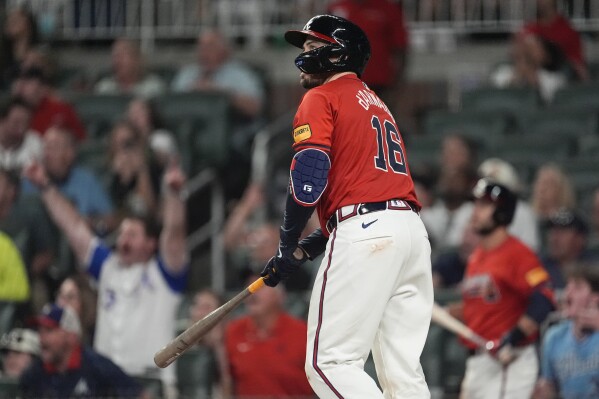 Atlanta Braves' Travis d'Arnaud hits a grand slam in the sixth inning of a baseball game against the Texas Rangers Friday, April 19, 2024, in Atlanta.The home run was d'Arnaud's third of the game. (AP Photo/John Bazemore)